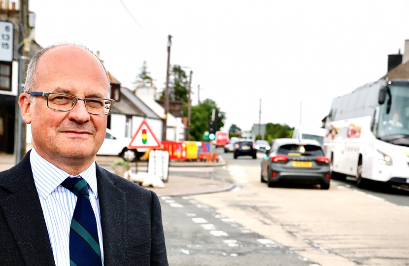 John standing by the A75 at Crocketford