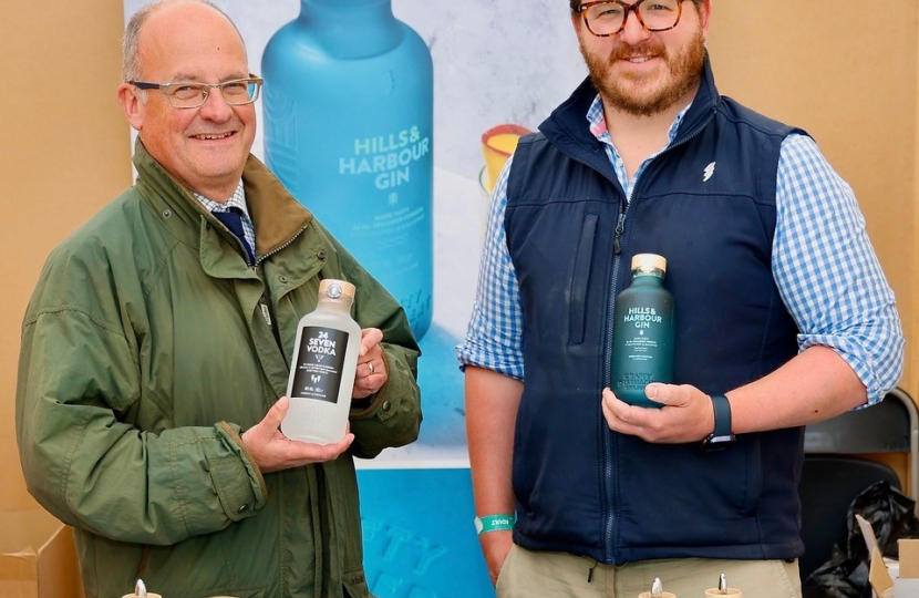 John with another man holding bottles