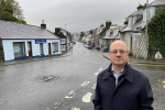 John Cooper looking towards camera on Victoria Street, Newton Stewart.